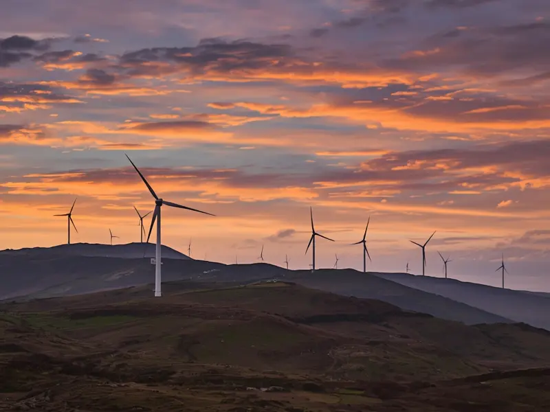 Wind turbines generating renewable energy across Northern Ireland's hillside landscape